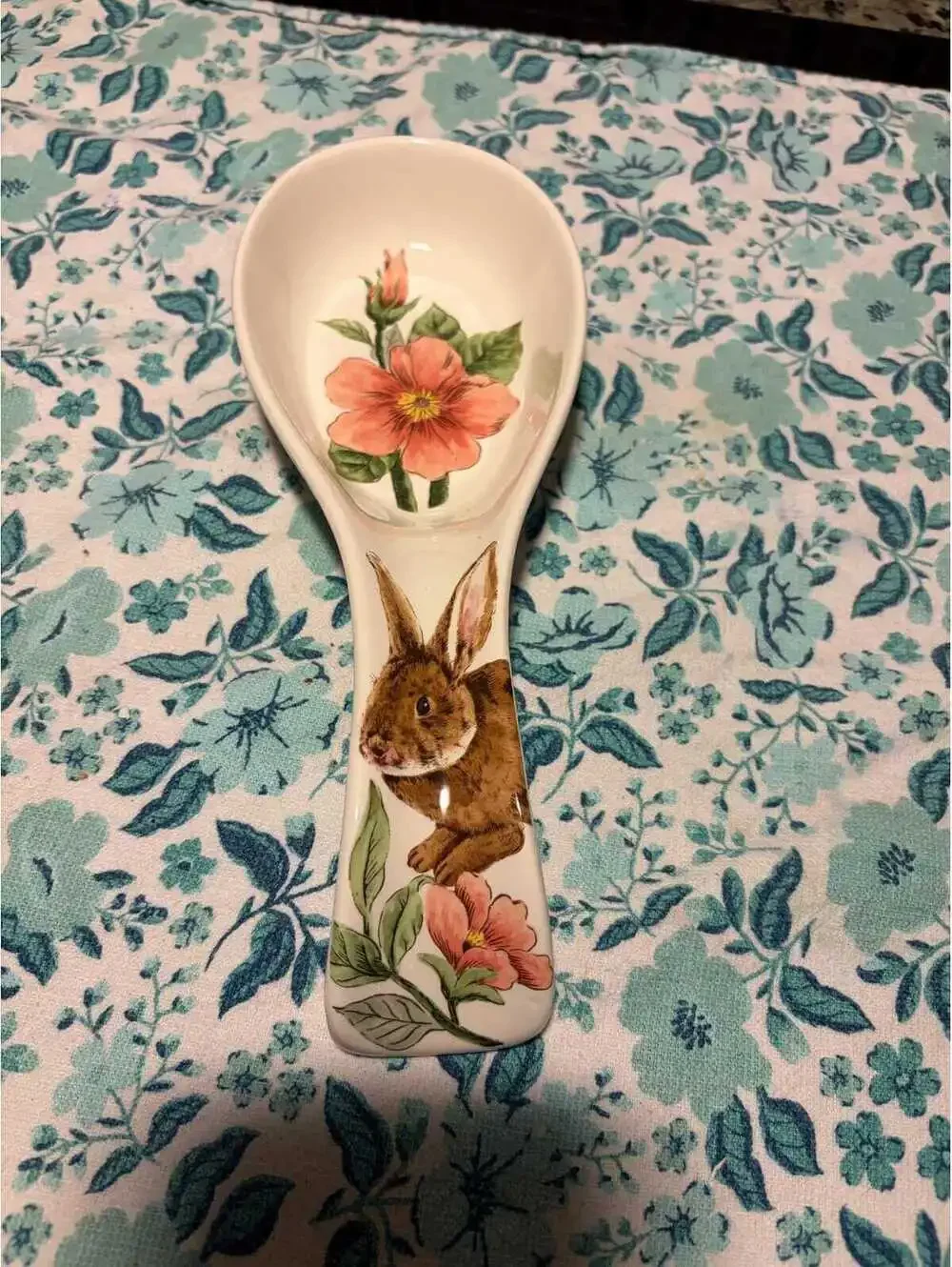 This is a Maxcera ceramic spoon rest featuring a rabbit and pink flowers.